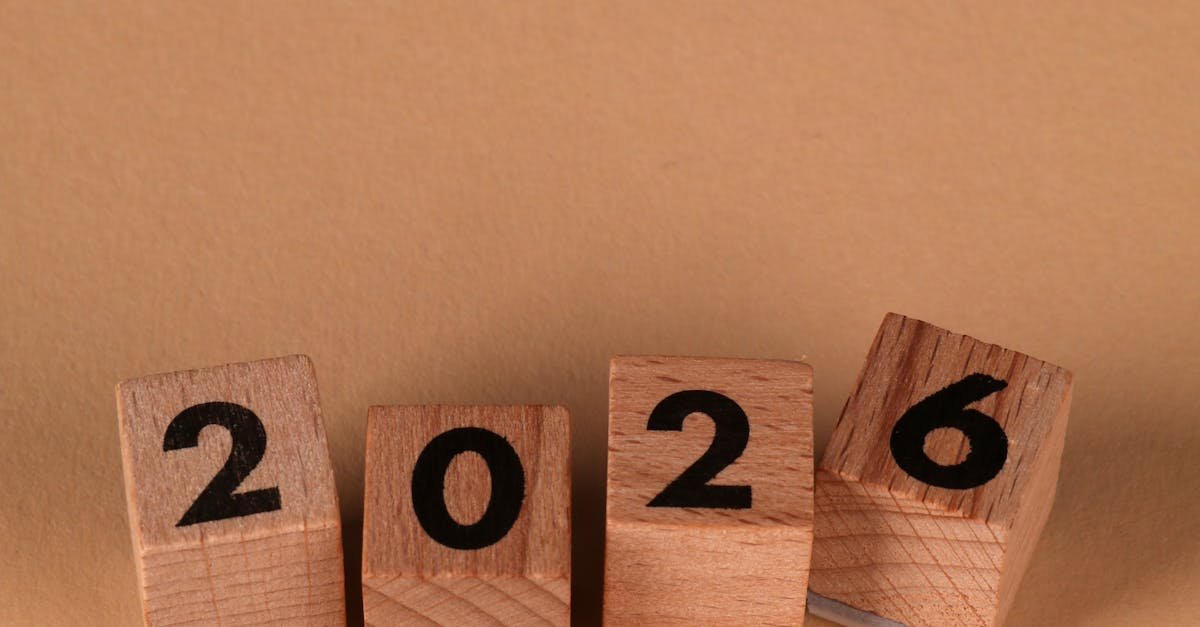 Wooden blocks forming the year 2026 on a warm beige background, symbolizing the new year.